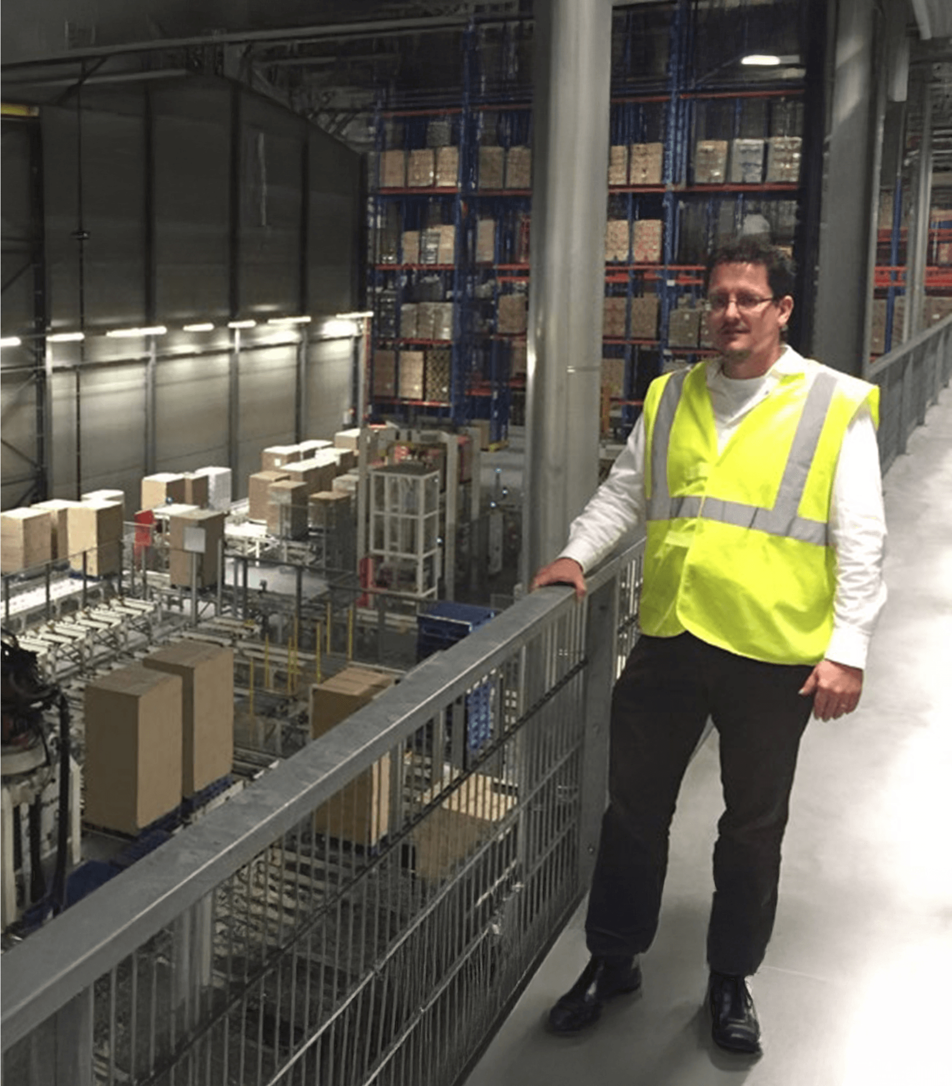 Man wearing a high visibility waistcoat in a warehouse