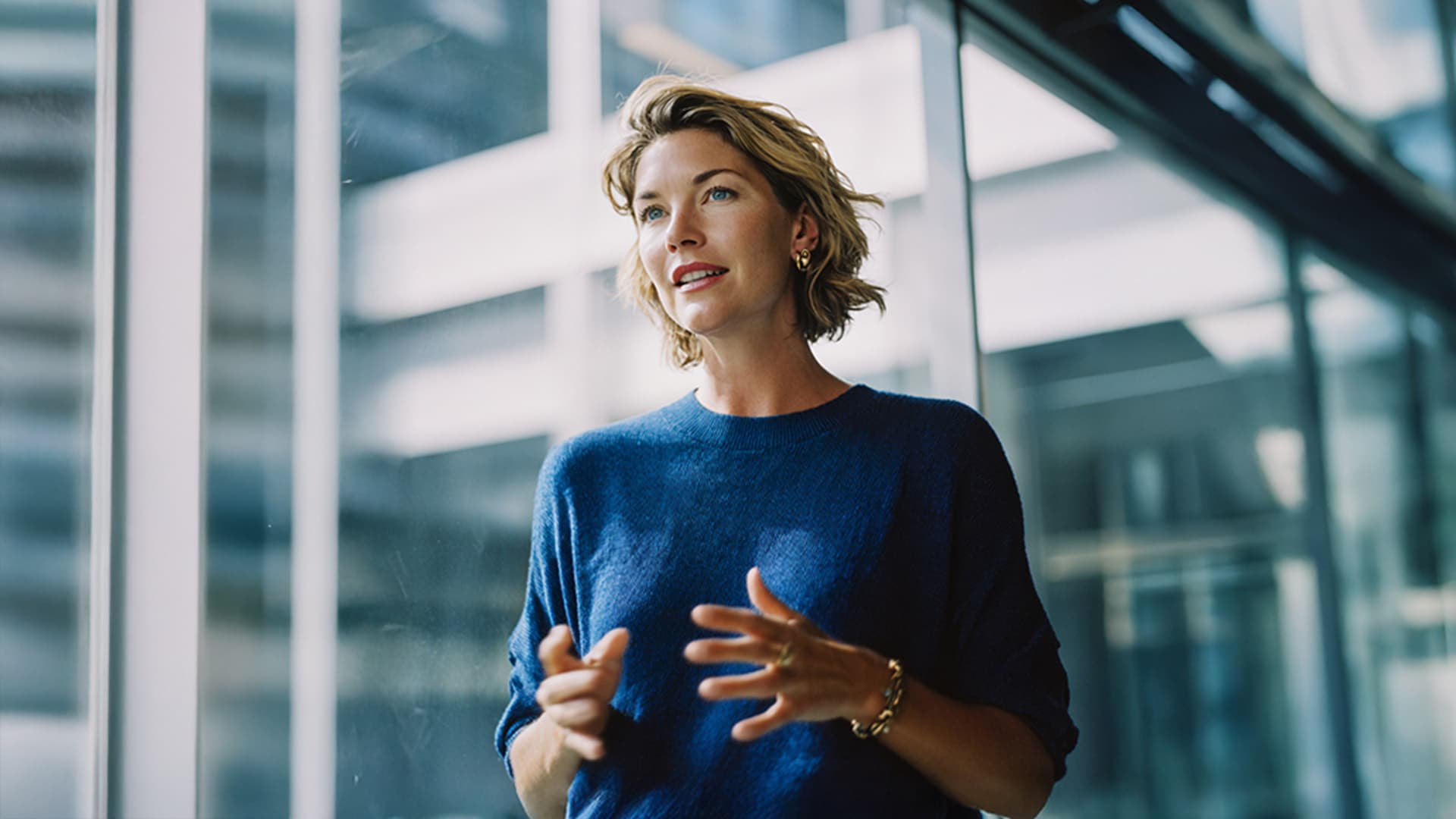 Woman standing in a meeting room delivering a