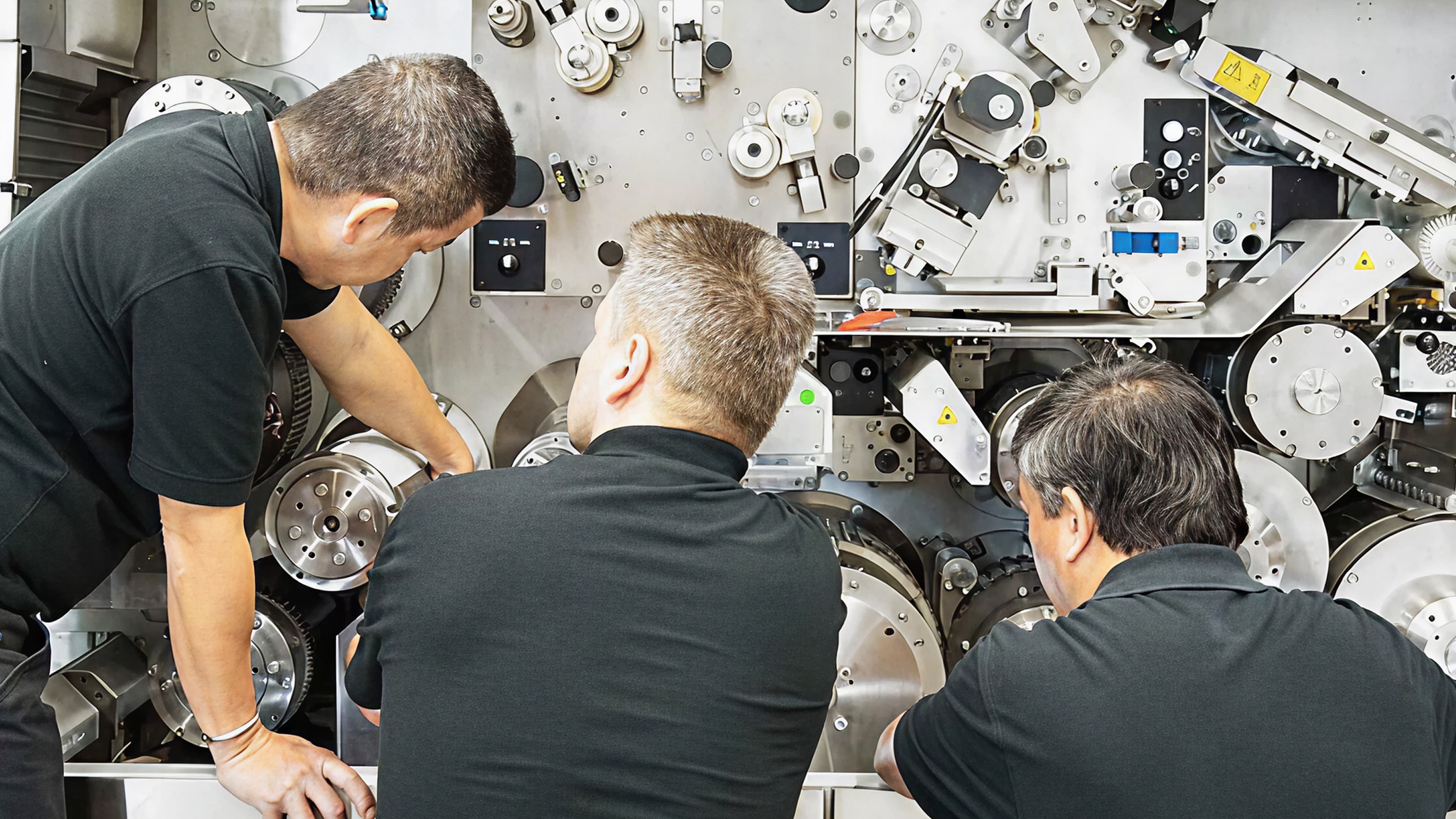 Team of workers inspecting machinery
