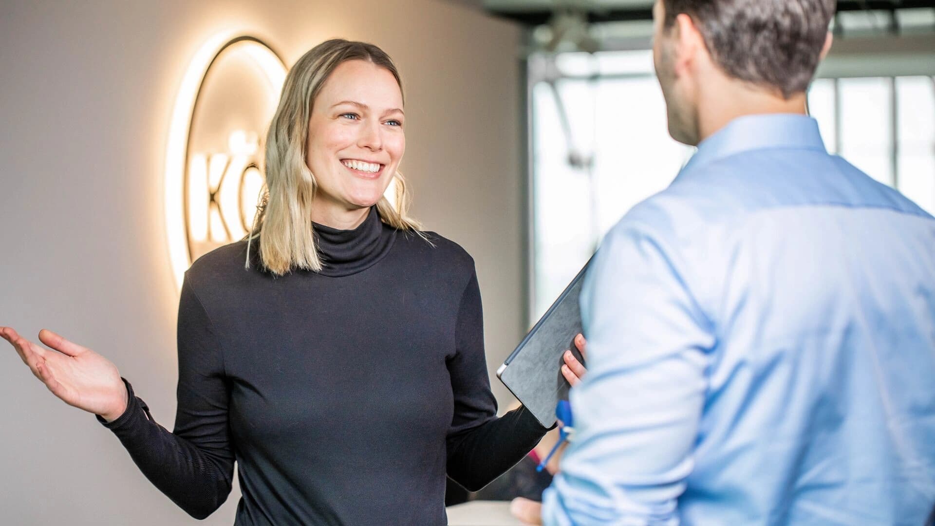 people in körber's office engaged in conversation