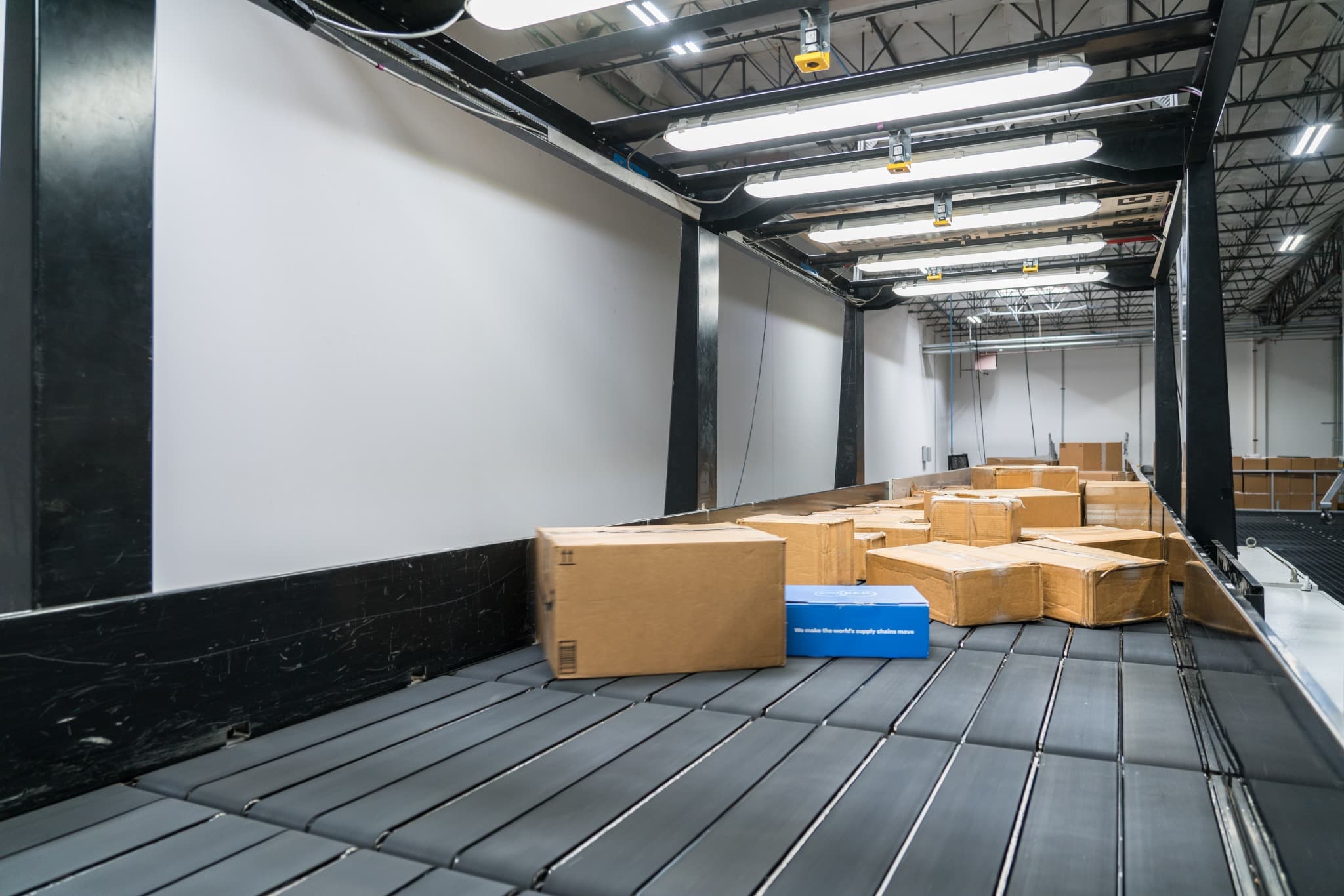 A spacious warehouse filled with stacked boxes and pallets