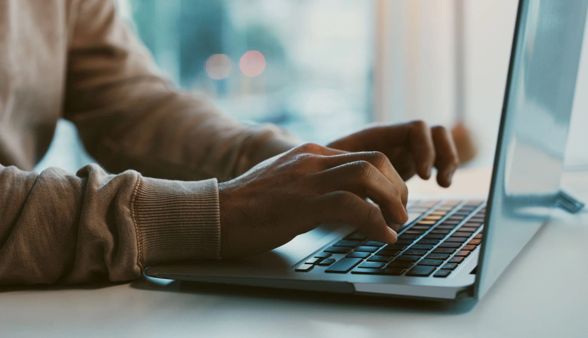 A person typing on a laptop