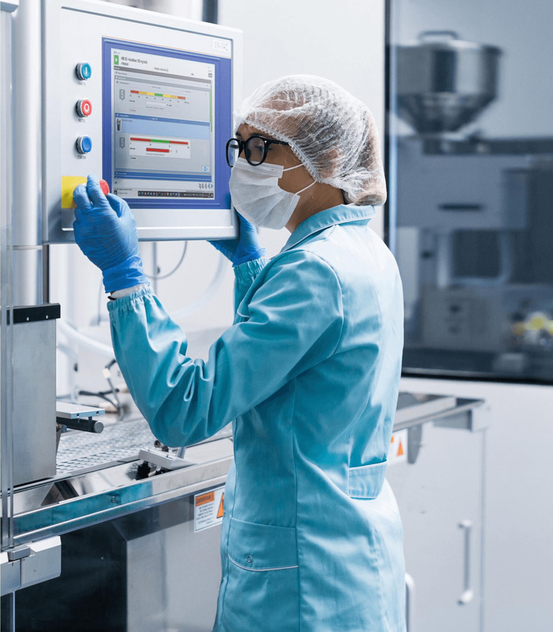 Man wearing personal protective equipment using Pas-X software on a touchscreen