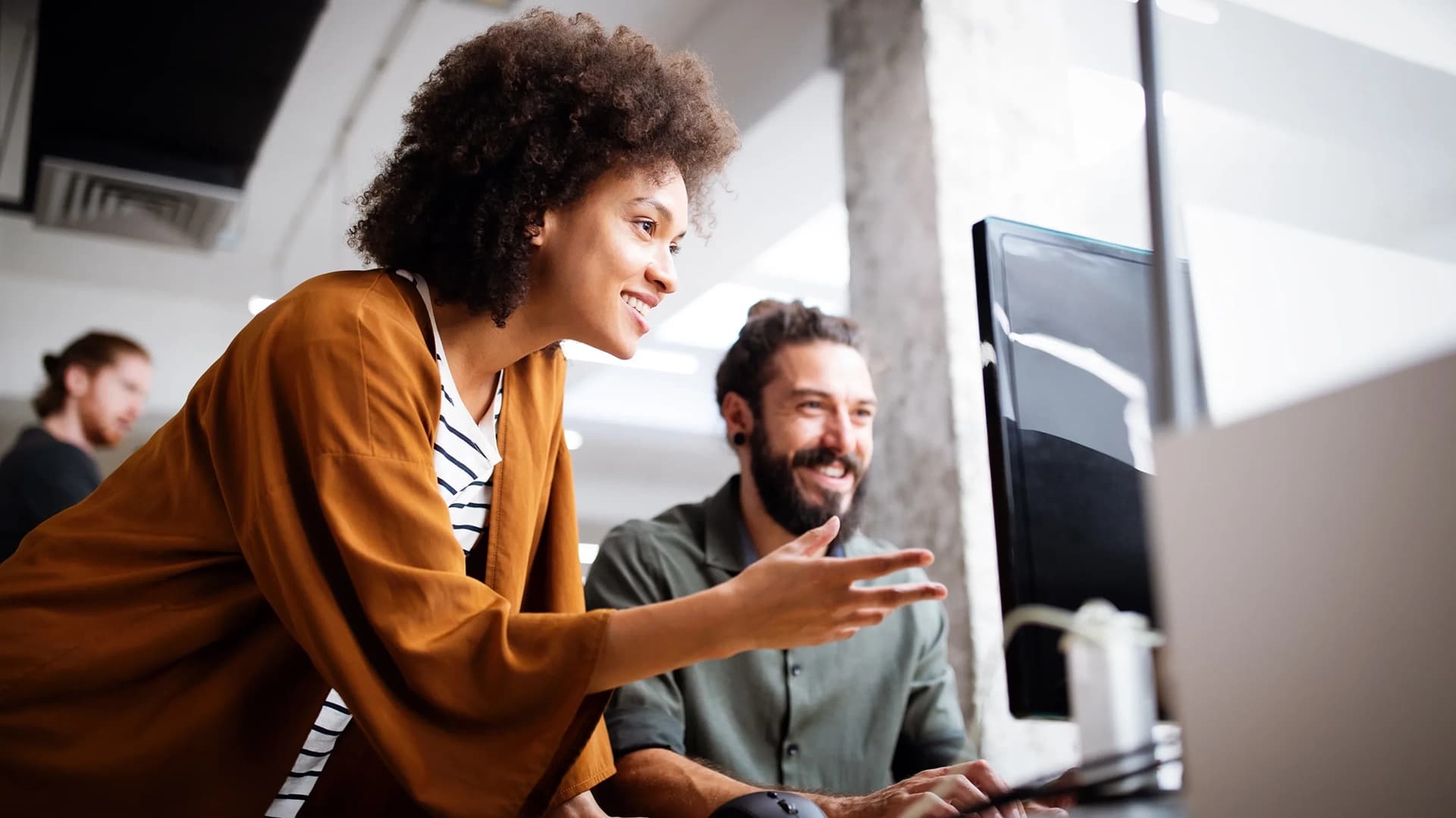 Two coworkers chatting in the office.