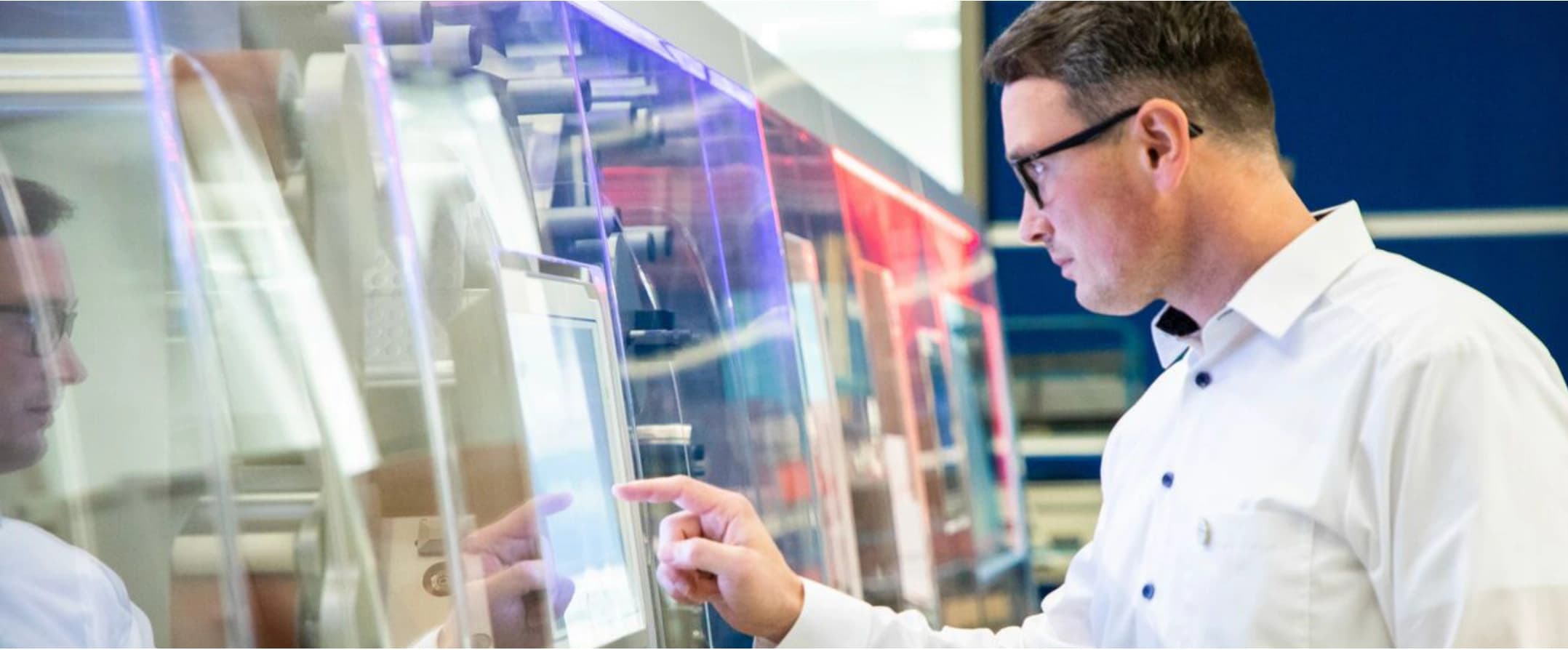 A man gazes intently at a computer screen, focused on his work.